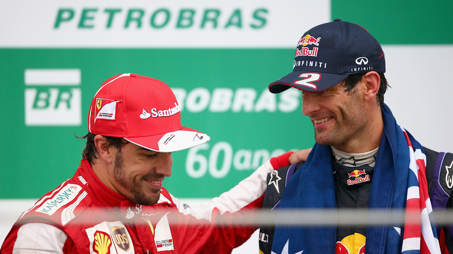 SAO PAULO, BRAZIL - NOVEMBER 24:  Second placed Mark Webber (R) of Australia and Infiniti Red Bull