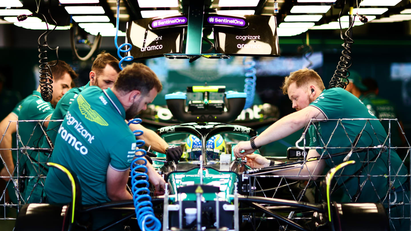 BAHRAIN, BAHRAIN - FEBRUARY 24: Members of the Aston Martin F1 team work on the car as Fernando