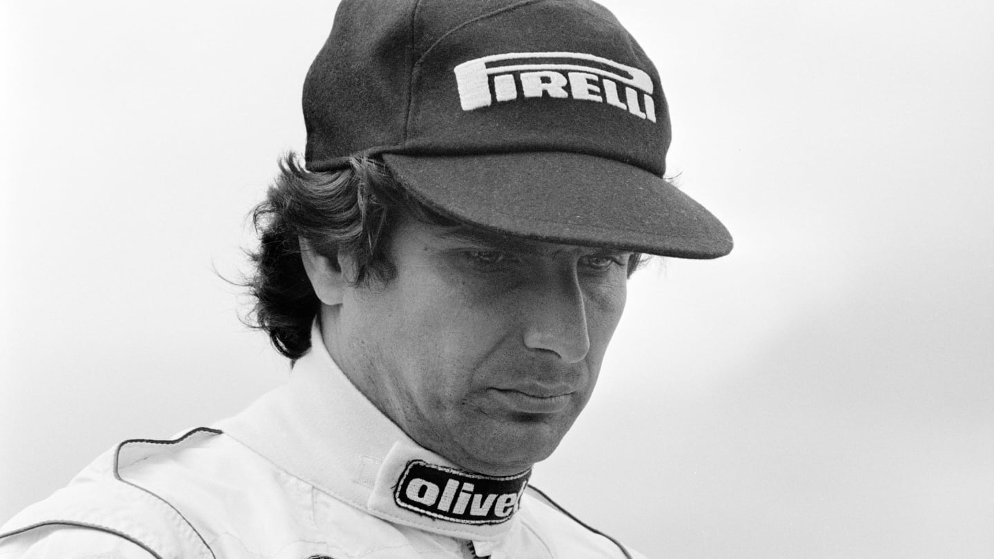 Formula One Grand Prix racing driver Nelson Piquet, driving for Brabham-BMW, stands in the pit lane