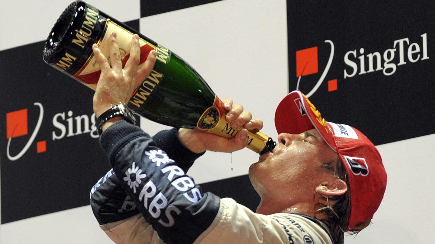 German driver Nico Rosberg of Williams drinks champagne to celebrate on the podium taking second
