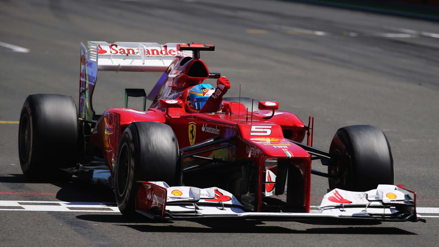 VALENCIA, SPAIN - JUNE 24:  Fernando Alonso of Spain and Ferrari celebrates as he crosses the