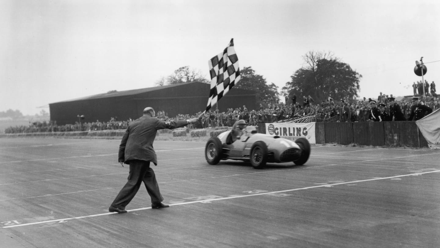 14th July 1951:  Froilan Gonzalez takes the winning flag in his Ferrari 375 at the British Grand