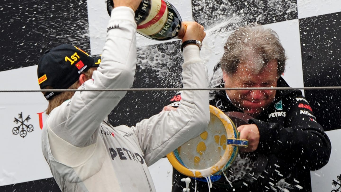 Mercedes-AMG driver Nico Rosberg (L) of Germany celebrates winning Formula One's Chinese Grand Prix