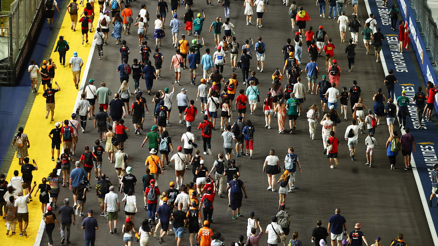 SINGAPORE, SINGAPORE - SEPTEMBER 17: Fans walkl on the grid after during the F1 Grand Prix of