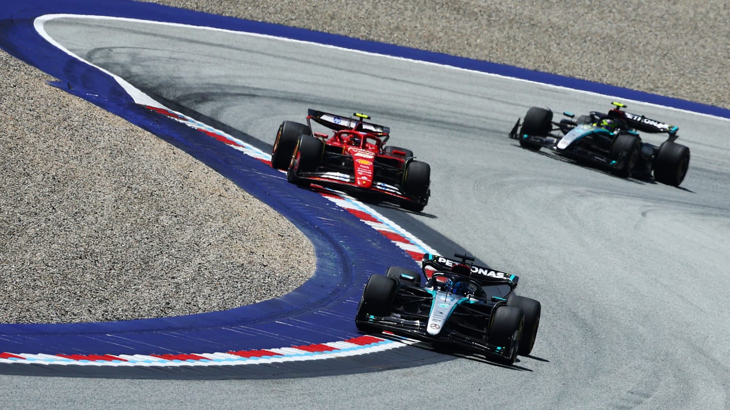 SPIELBERG, AUSTRIA - JUNE 29: George Russell of Great Britain driving the (63) Mercedes AMG Petronas F1 Team W15 leads Carlos Sainz of Spain driving (55) the Ferrari SF-24 on track during the Sprint ahead of the F1 Grand Prix of Austria at Red Bull Ring on June 29, 2024 in Spielberg, Austria. (Photo by Clive Rose/Getty Images)
