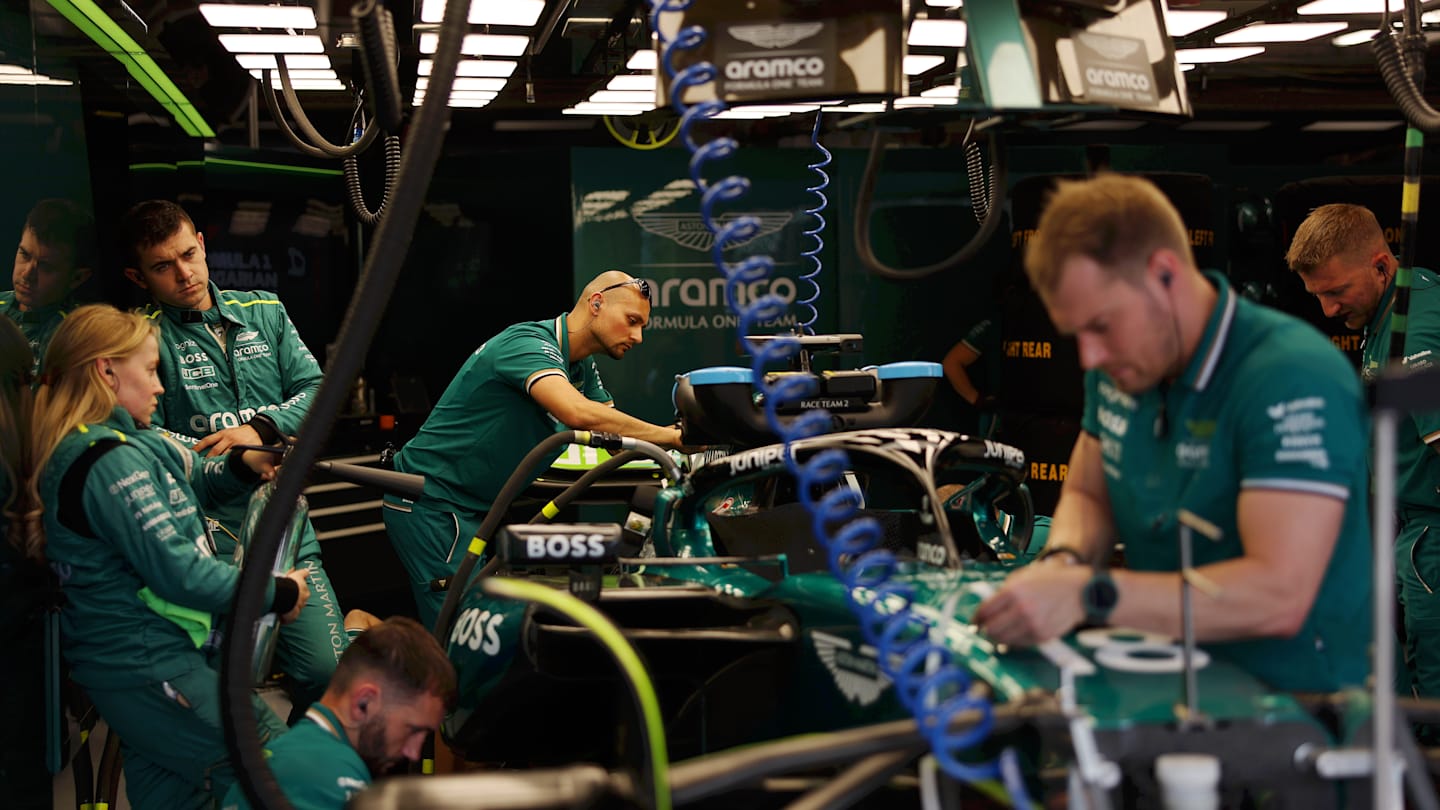 BUDAPEST, HUNGARY - JULY 20: The Aston Martin F1 team work on the car of Lance Stroll of Canada and