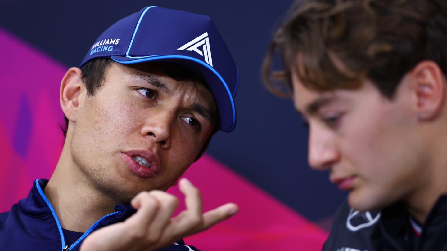 SUZUKA, JAPAN - APRIL 04: Alexander Albon of Thailand and Williams talks with George Russell of