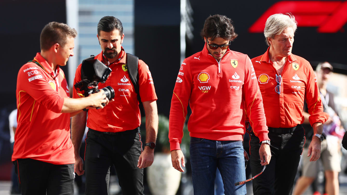 JEDDAH, SAUDI ARABIA - MARCH 07: Carlos Sainz of Spain and Ferrari walks in the Paddock prior to