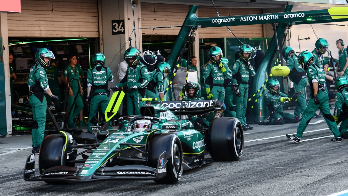 Aston Martin's Spanish driver Fernando Alonso leaves the paddock after a pitstop during the Formula