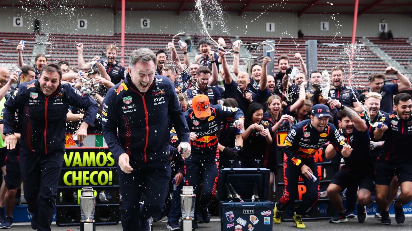 Christian Horner, Max Verstappen and Sergio Perez of Red Bull Racing celebrate with the team after