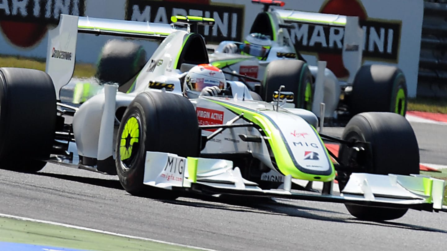 Brawn GP's Brazilian driver Rubens Barrichello drives ahead of Brawn GP's British driver Jenson