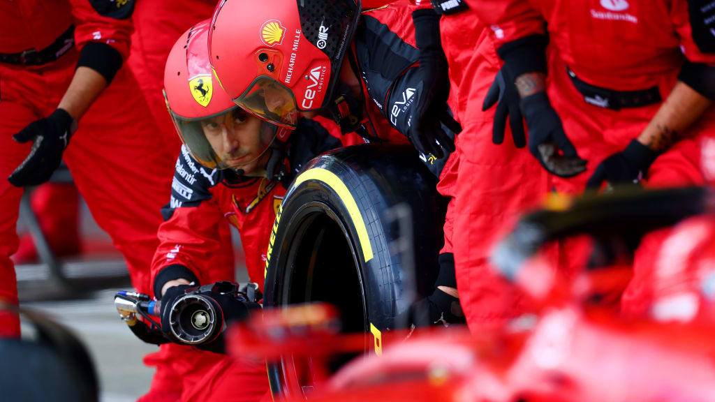 NORTHAMPTON, ENGLAND - JULY 09: Ferrari mechanics prepare for a pit stop in the pit lane during the