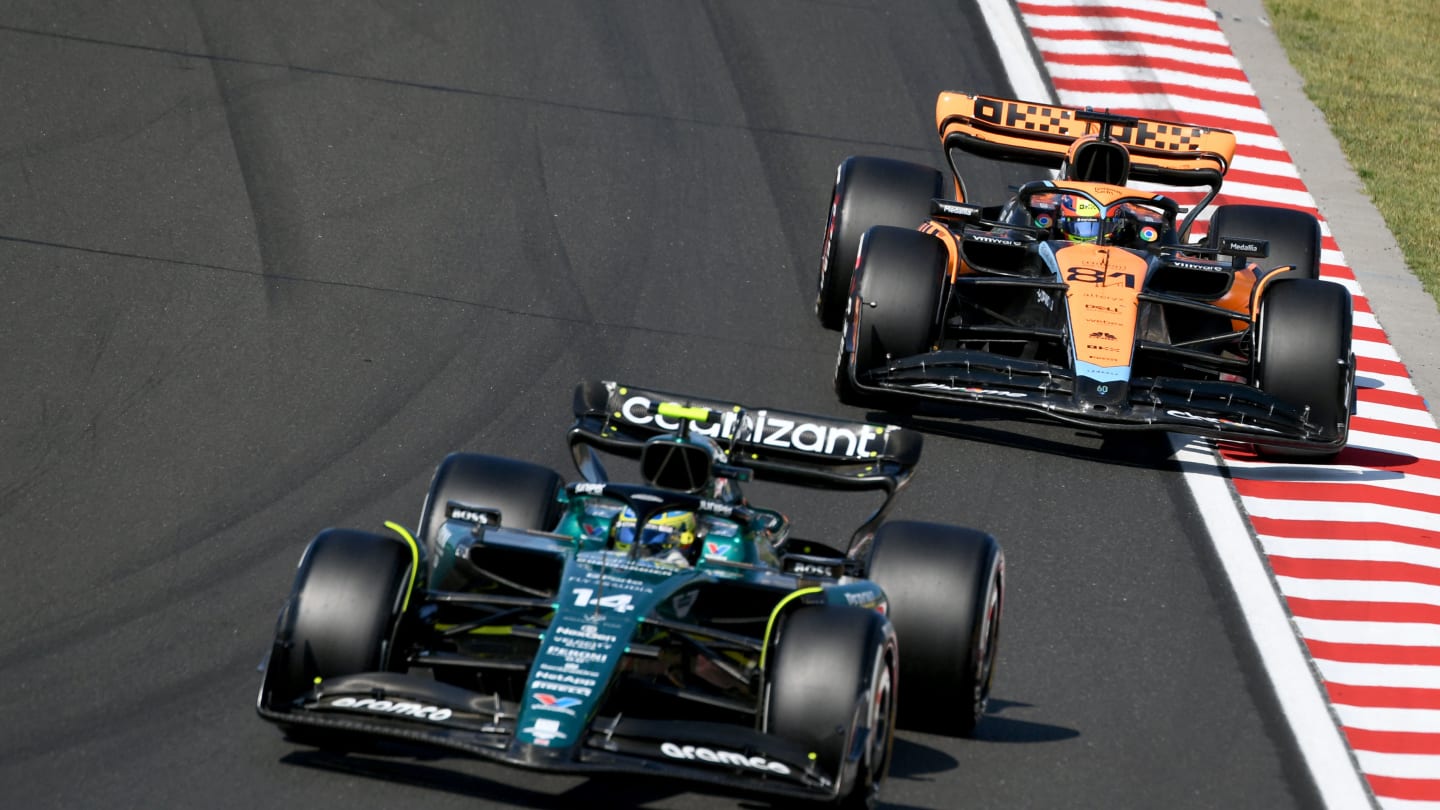 Aston Martin's Spanish driver Fernando Alonso (L) and McLaren's Australian driver Oscar Piastri