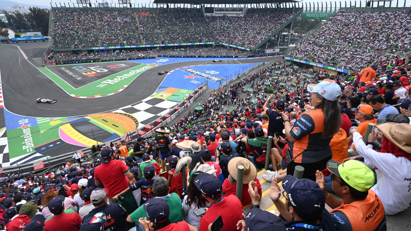 TOPSHOT - Spectators watch the Formula One Mexico Grand Prix at the Hermanos Rodriguez racetrack in