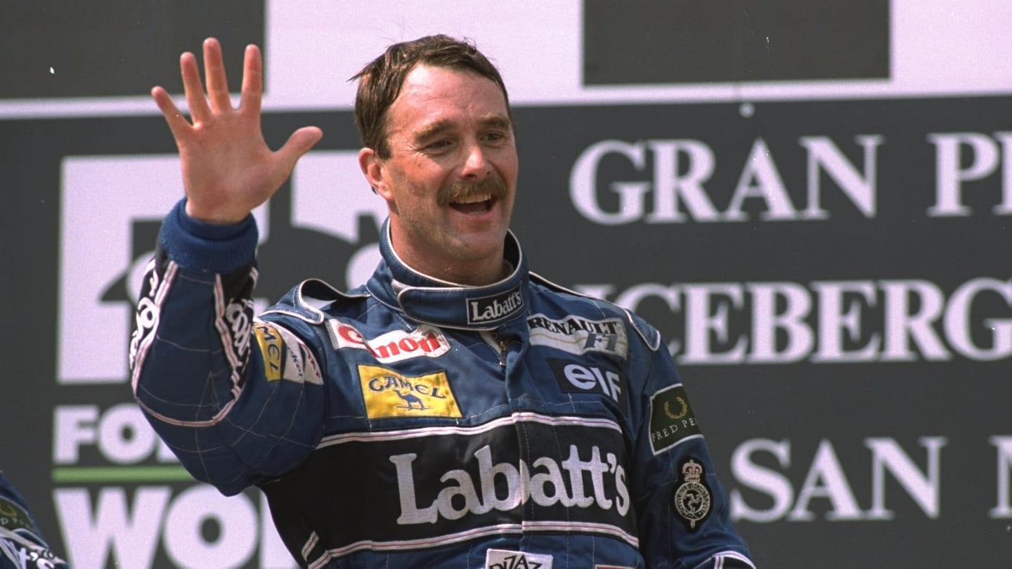 1992:  Williams Renault driver Nigel Mansell of Great Britain waves to the crowd as he stands on