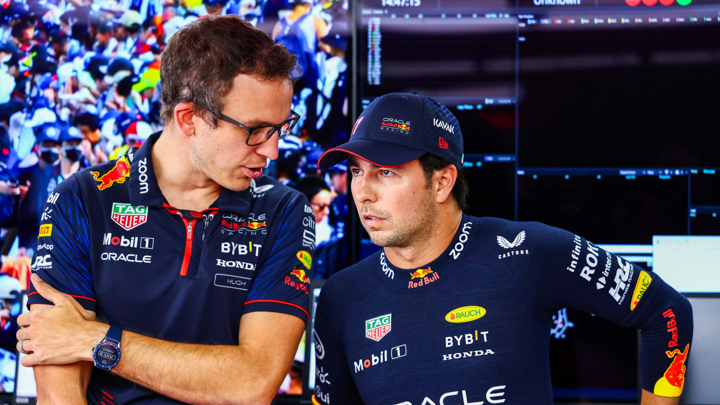 SUZUKA, JAPAN - SEPTEMBER 23: Sergio Perez of Mexico and Oracle Red Bull Racing talks with race