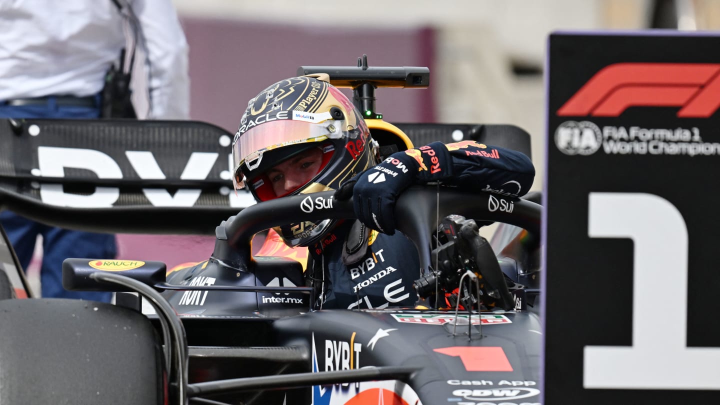 Red Bull Racing's Dutch driver Max Verstappen gets out of his car after winning the pole position
