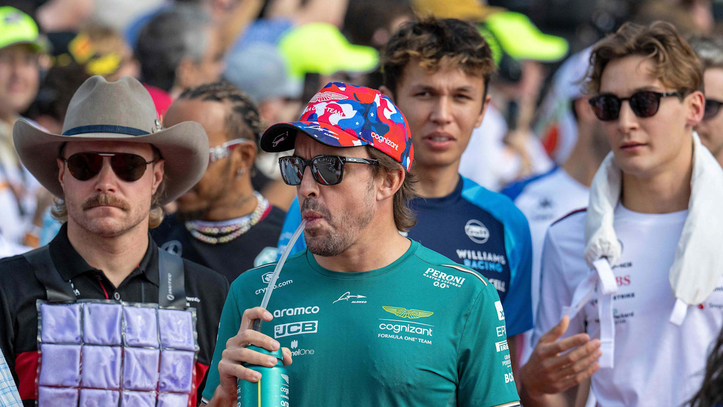 (L-R) Alfa Romeo's Finnish driver Valtteri Bottas, Aston Martin's Spanish driver Fernando Alonso,