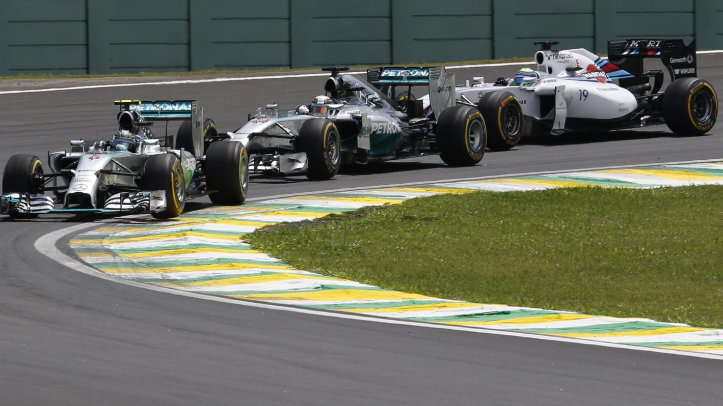 German driver Nico Rosberg (L) and Bristish Lewis Hamilton (C) of Mercedes AMG Petronas and