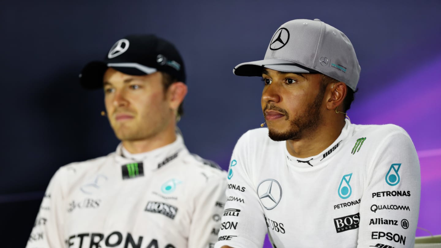 SINGAPORE - SEPTEMBER 17:  Lewis Hamilton of Great Britain and Mercedes GP and Nico Rosberg of