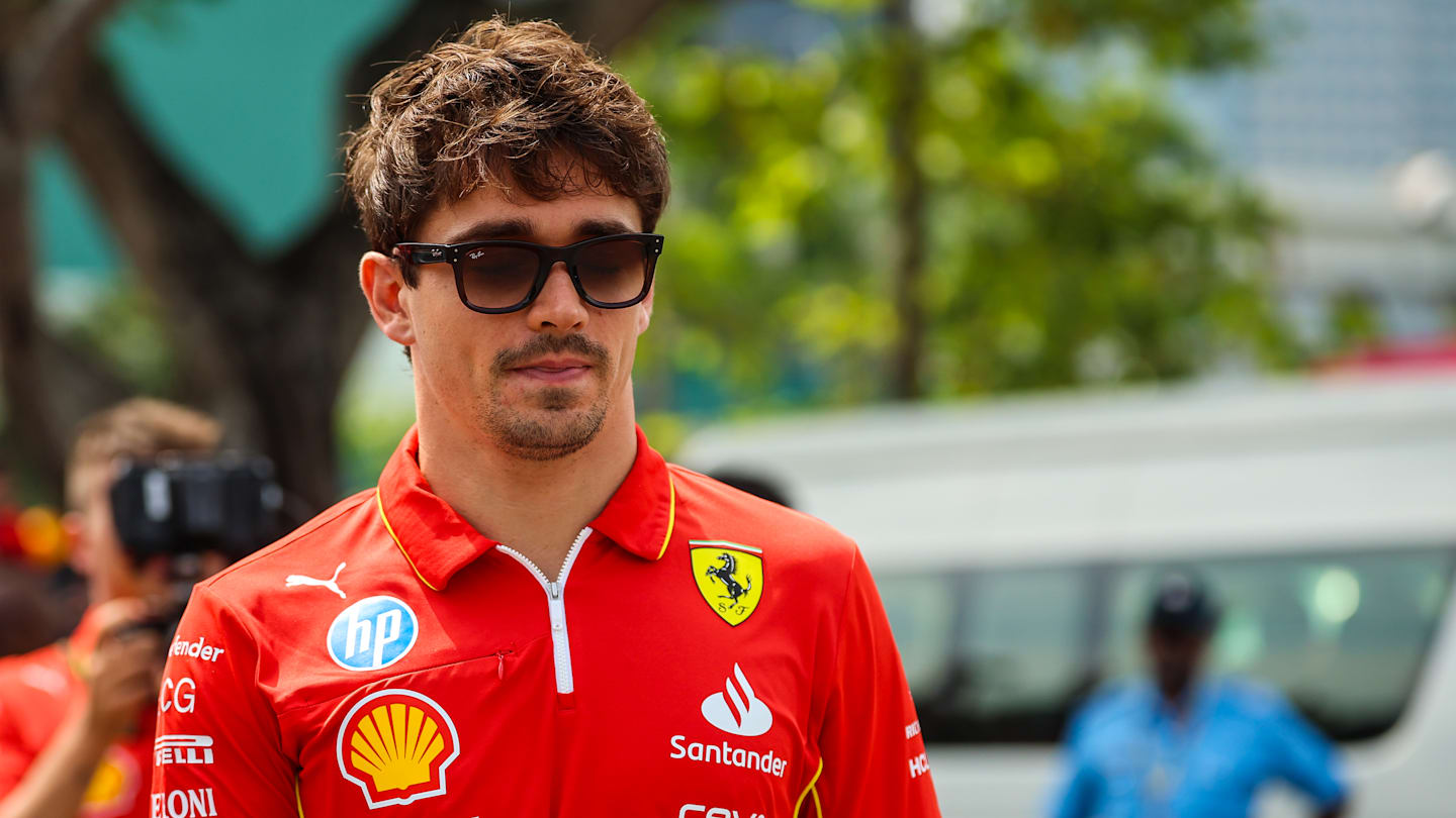 SINGAPORE, SINGAPORE - SEPTEMBER 20: Charles Leclerc of Monaco and Ferrari walks in the paddock
