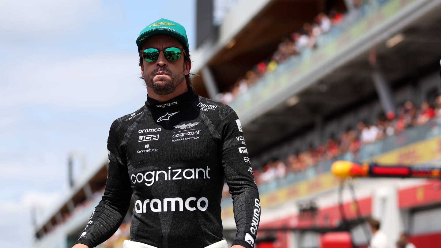 MONTREAL, QUEBEC - JUNE 18: Fernando Alonso of Spain and Aston Martin F1 Team walks to the grid