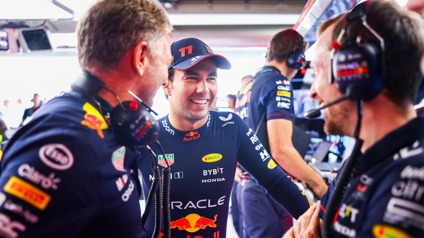 SUZUKA, JAPAN - SEPTEMBER 23: Sergio Perez of Mexico and Oracle Red Bull Racing talks with Red Bull
