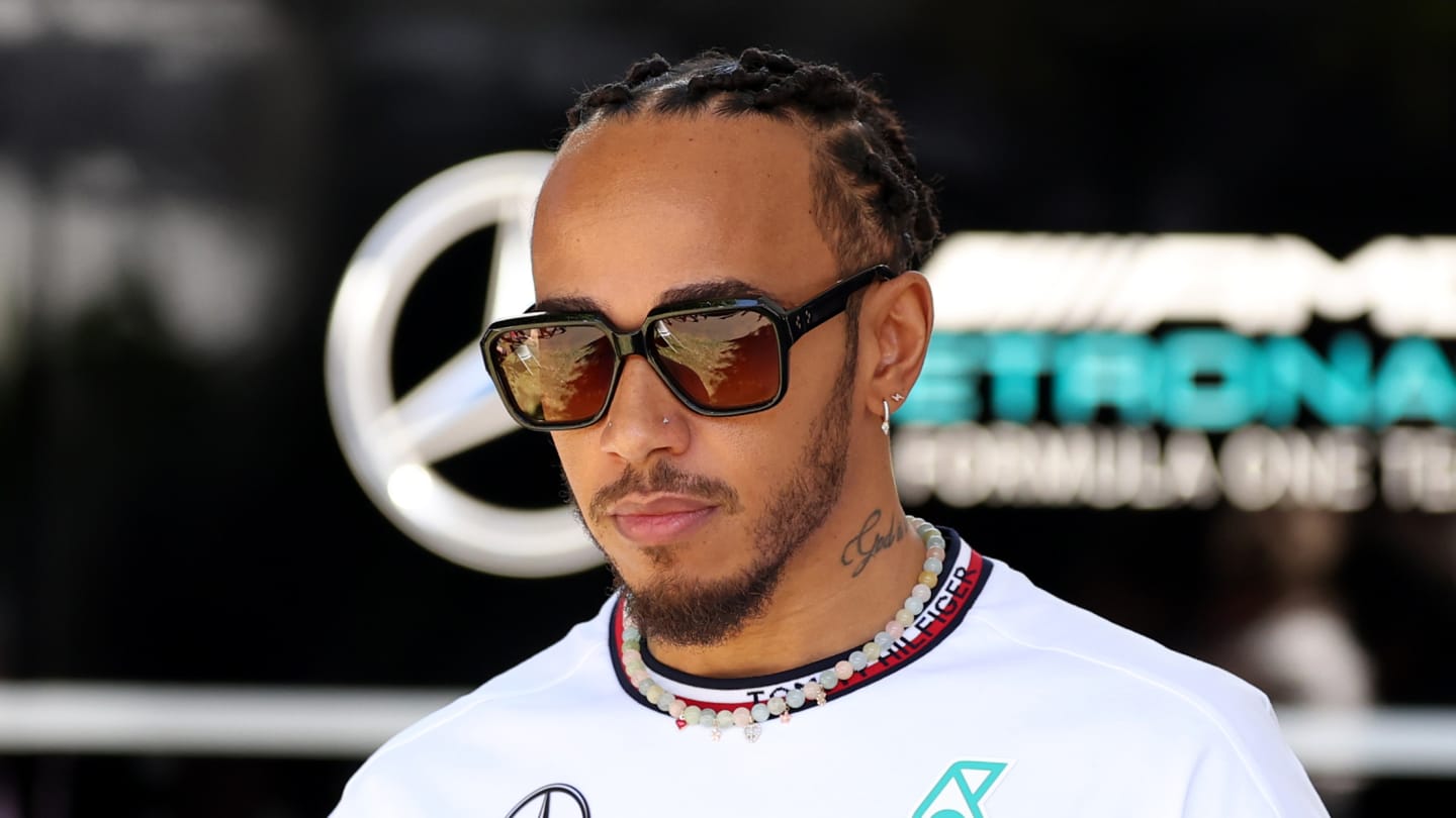 MELBOURNE, AUSTRALIA - MARCH 21: Lewis Hamilton of Great Britain and Mercedes walks in the Paddock