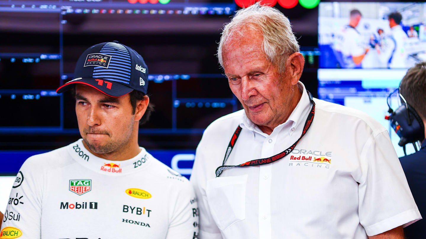 SPIELBERG, AUSTRIA - JUNE 28: Sergio Perez of Mexico and Oracle Red Bull Racing and Oracle Red Bull Racing Team Consultant Dr Helmut Marko look on in the garage  prior to Sprint Qualifying. (Photo by Mark Thompson/Getty Images)