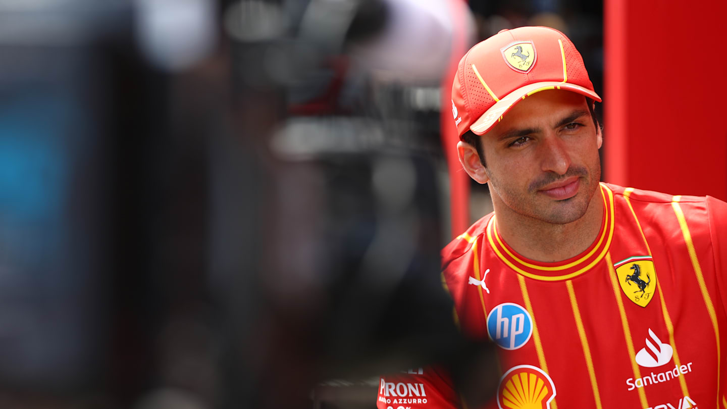 SPIELBERG, AUSTRIA - JUNE 27: Carlos Sainz of Spain and Ferrari talks to the media in the Paddock