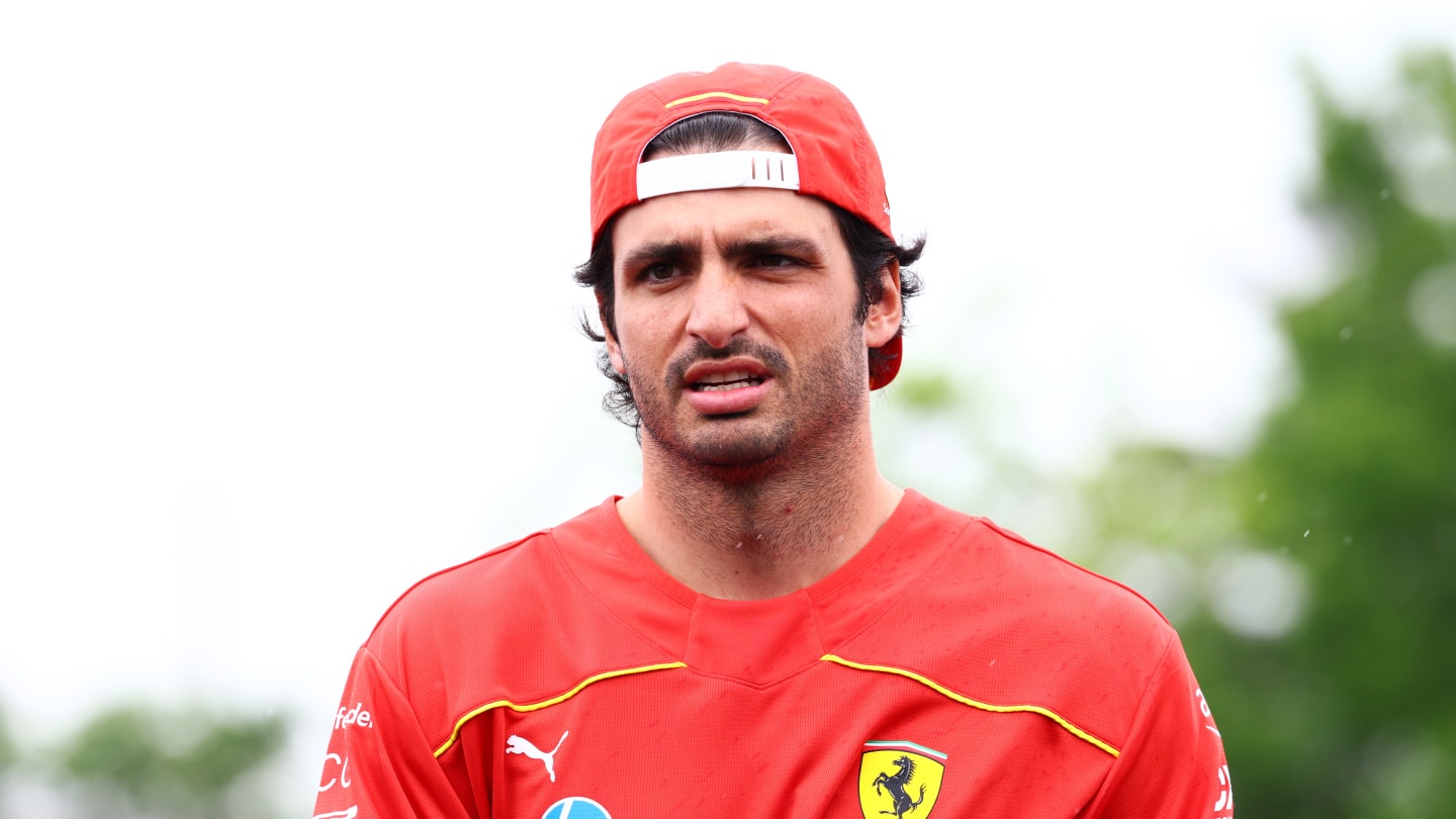 MONTREAL, QUEBEC - JUNE 06: Carlos Sainz of Spain and Ferrari walks in the Paddock during previews