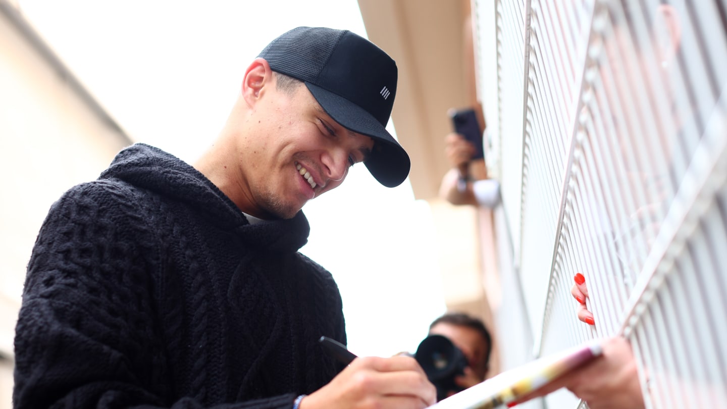 Lando Norris signs autographs for fans