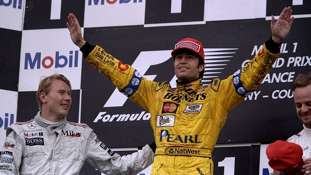27 Jun 1999:  Heinz-Harald Frentzen of the Jordan team is congratulated by Mika Hakkinen of McLaren