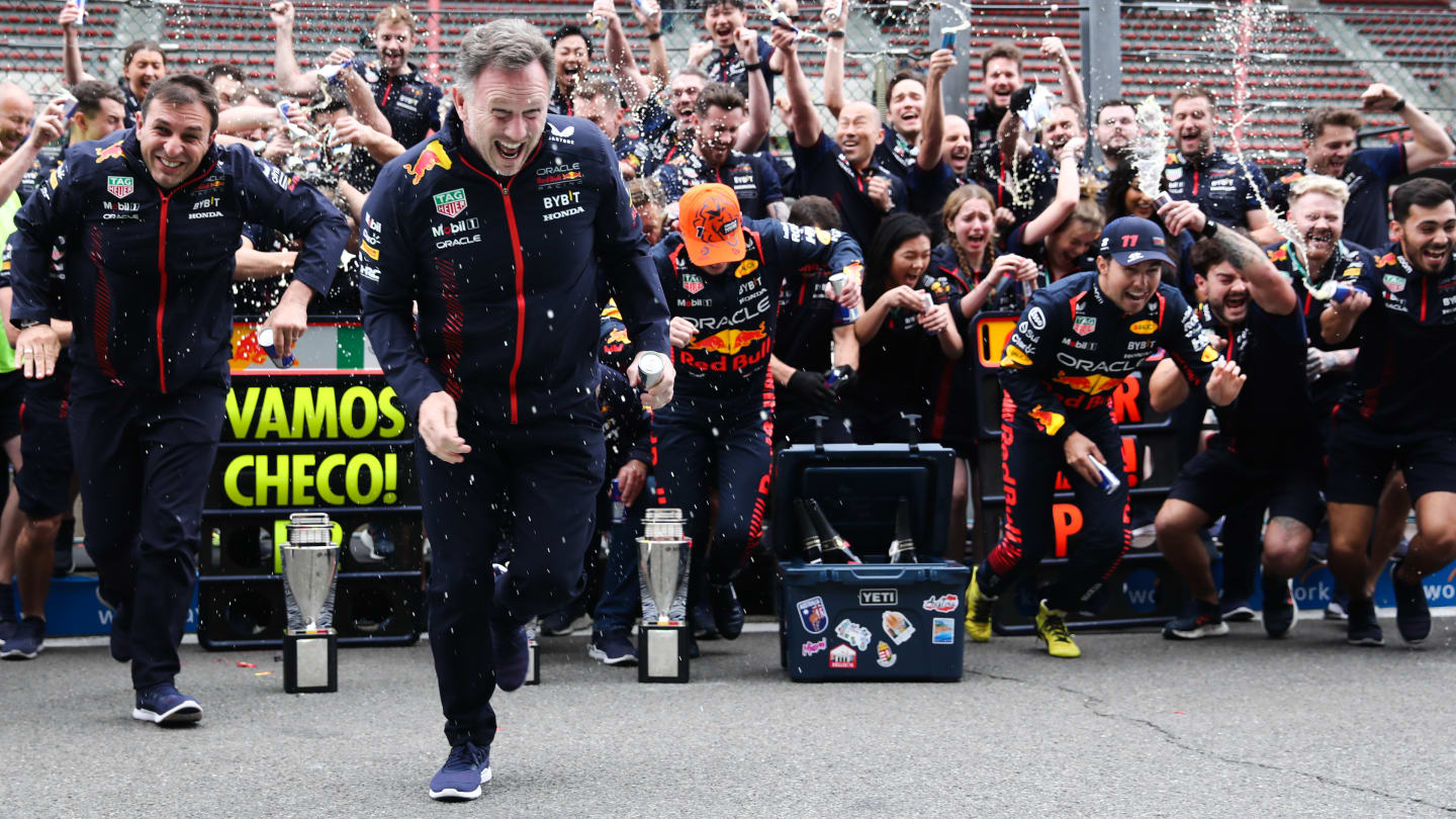 Christian Horner, Max Verstappen and Sergio Perez of Red Bull Racing celebrate with the team after