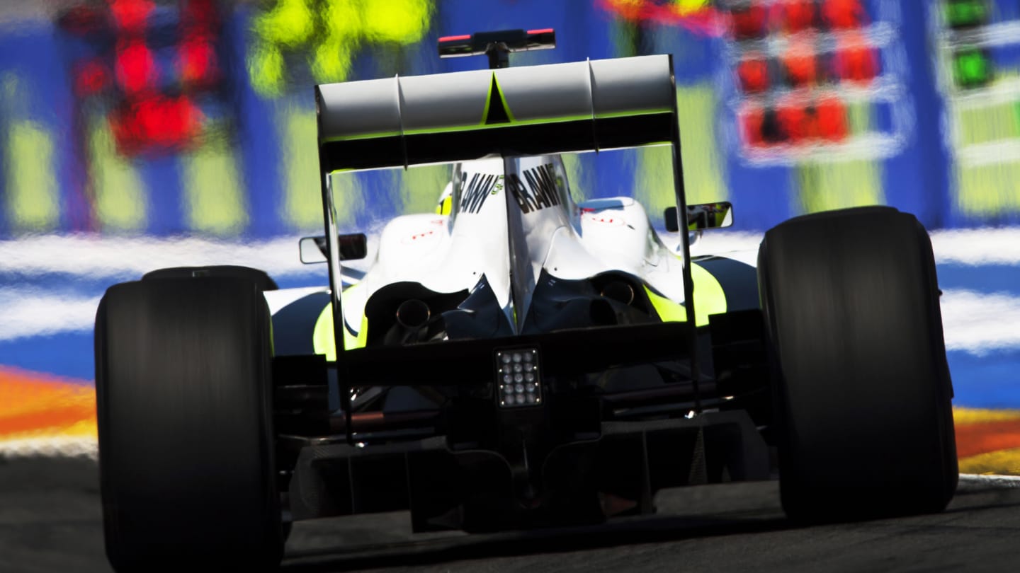 British Brawn Formula One driver Jenson Button driving his Brawn BGP 001 racing car past the pit