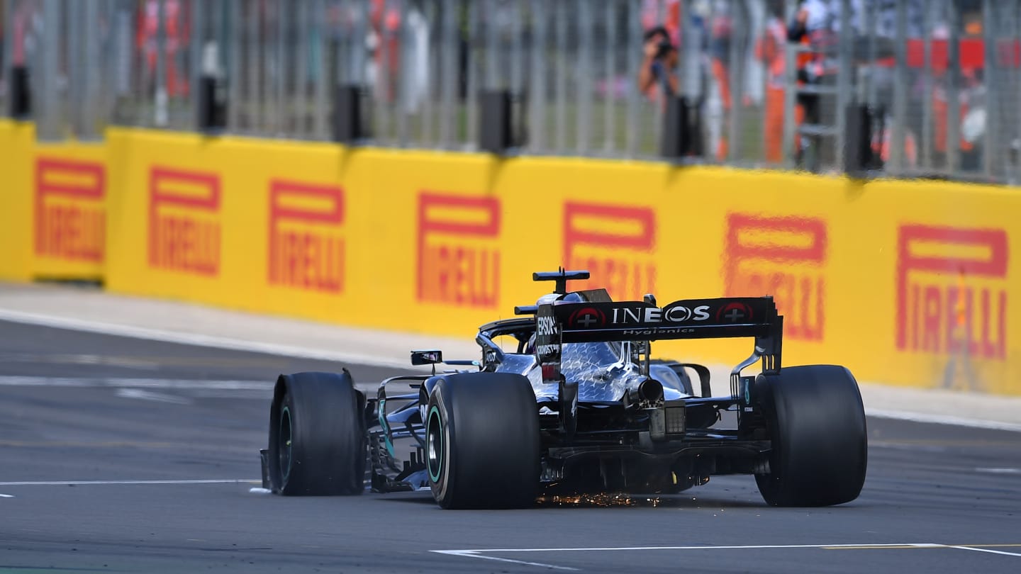 Mercedes' British driver Lewis Hamilton drives with a puncture before winning the Formula One