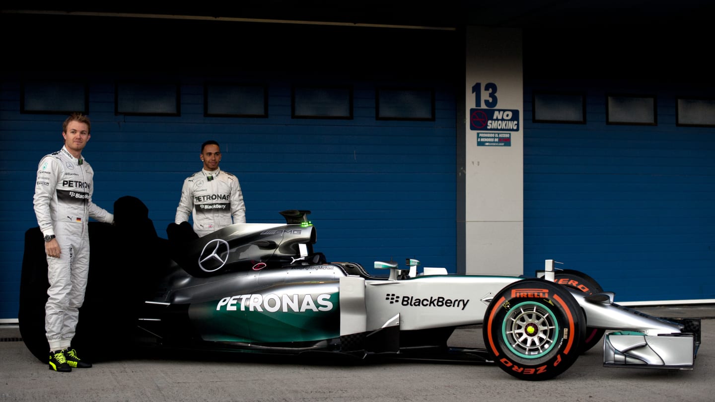 British driver Lewis Hamilton (R) and German driver Nico Rosberg pose during the unveiling of the