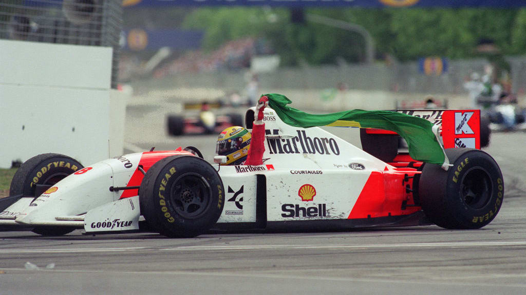 Brazilian Formula One champion Ayrton Senna takes his victory lap 07 November 1993 after the