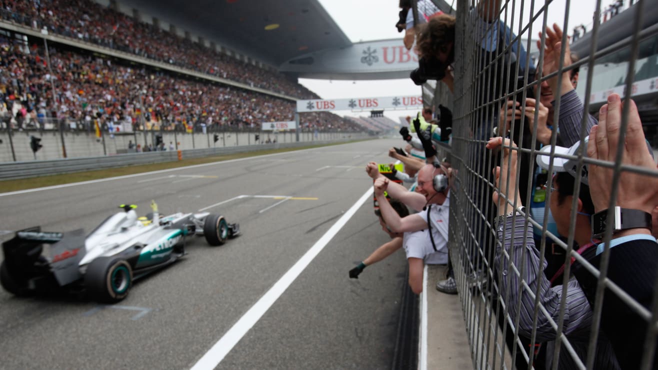 Mercedes-AMG driver Nico Rosberg of Germany is cheered by crew members in the pit wall after