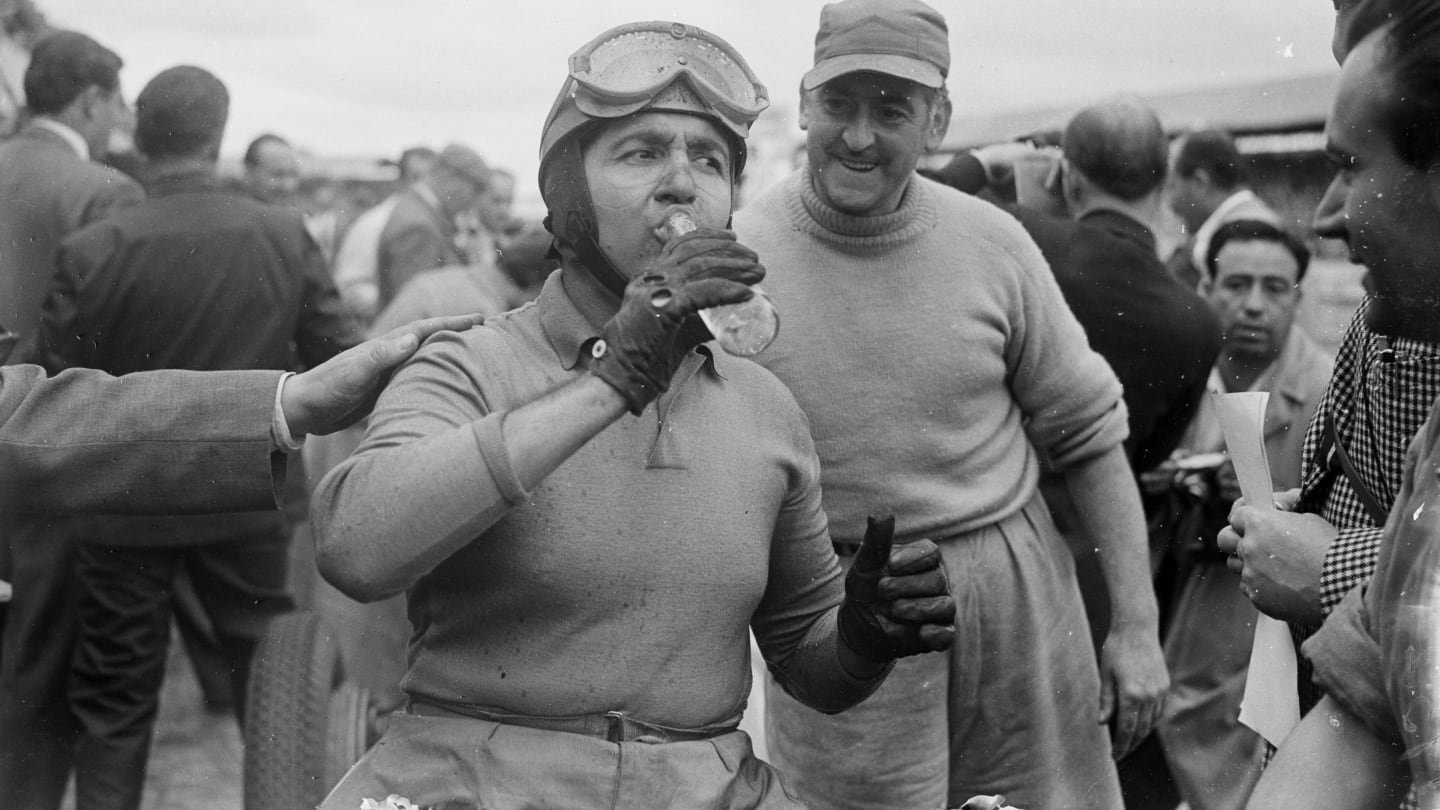 21st July 1952:  Italian racing driver Alberto Ascari (1918 - 1955) toasts his victory in the