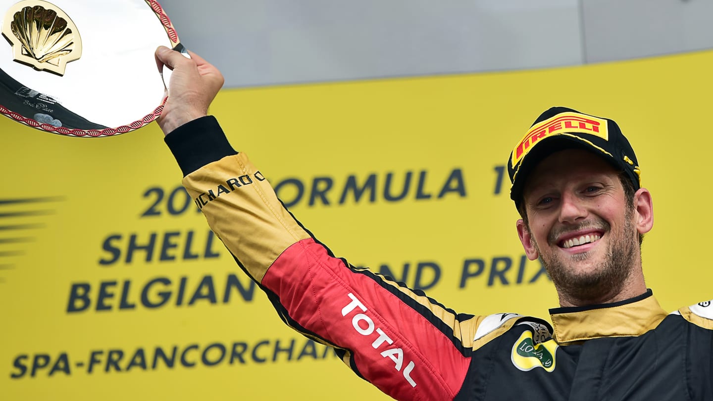 Third-placed Lotus F1 Team's French driver Romain Grosjean celebrates with his trophy on the podium