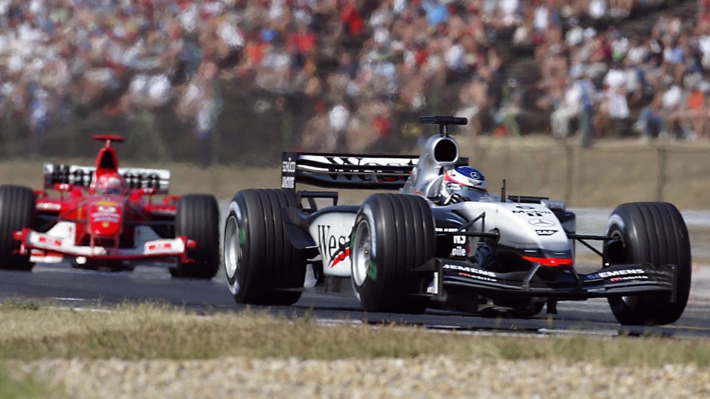 McLaren-Mercedes driver Kimi Raikkonen steers his car ahead of German BMW-Williams driver Ralf