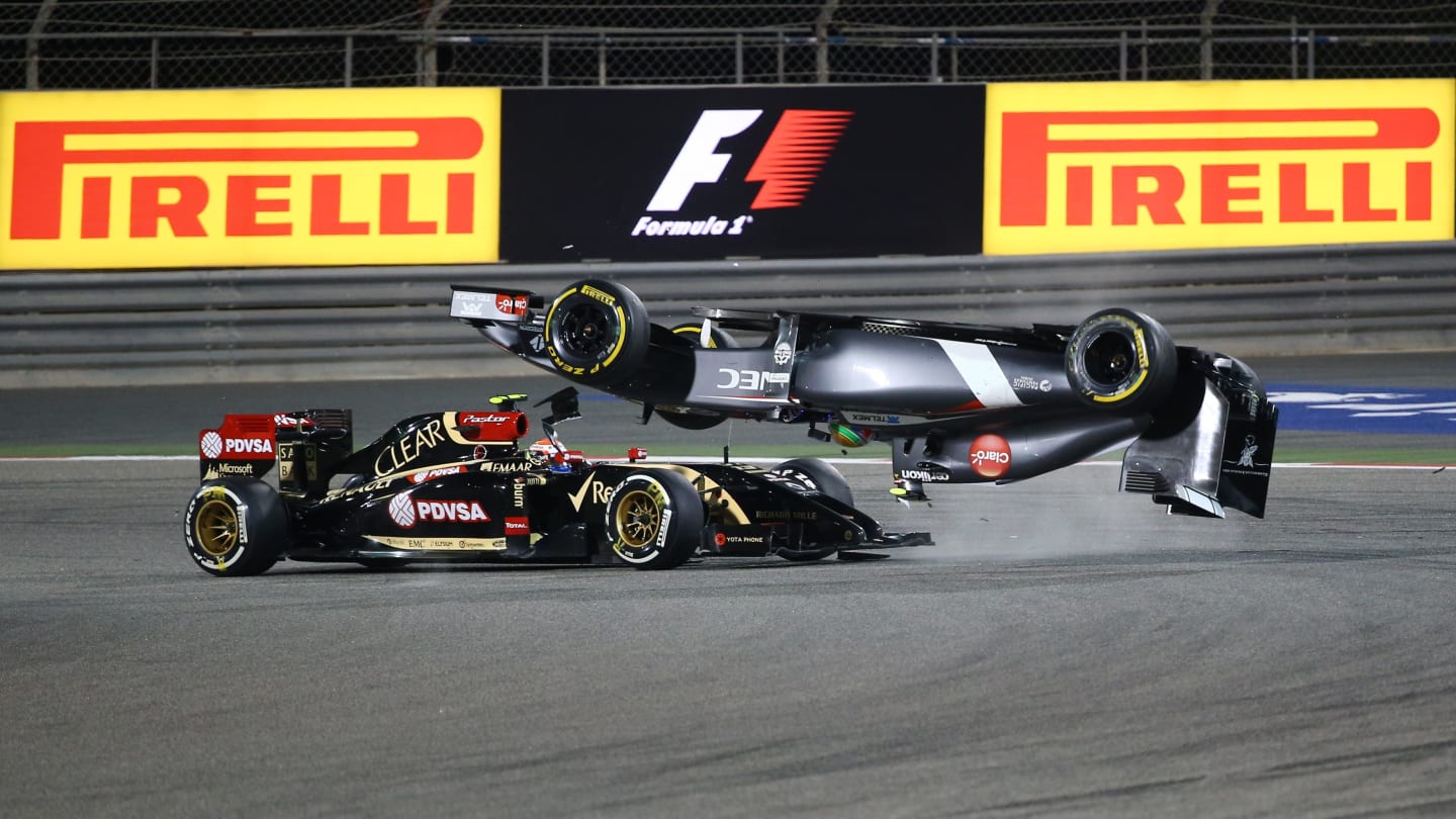 Sauber driver Esteban Gutierrez of Mexico crashes ahead of Lotus driver Pastor Maldonado of