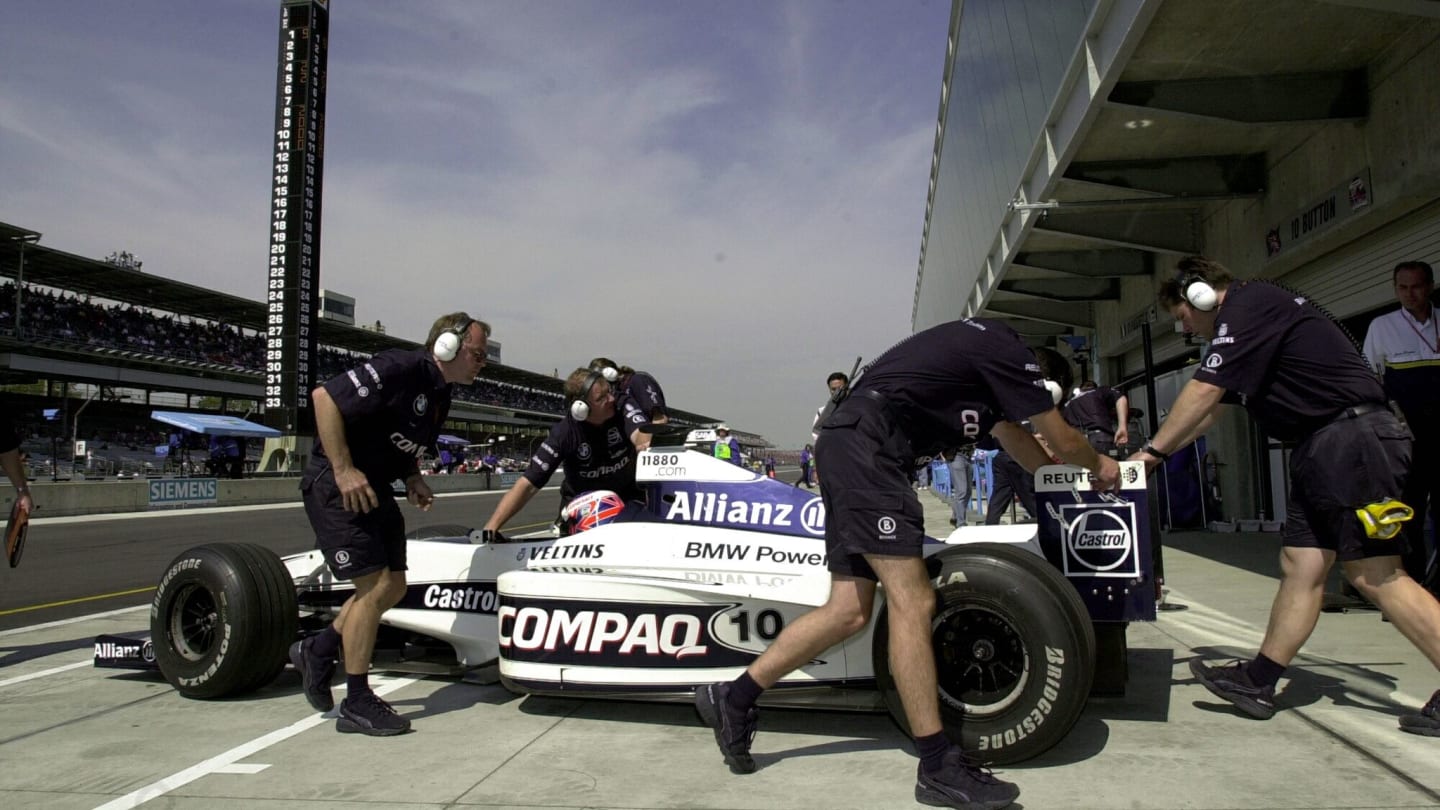 INDIANAPOLIS, UNITED STATES:  Crew members roll the car of Williams driver Jenson Button, of Great