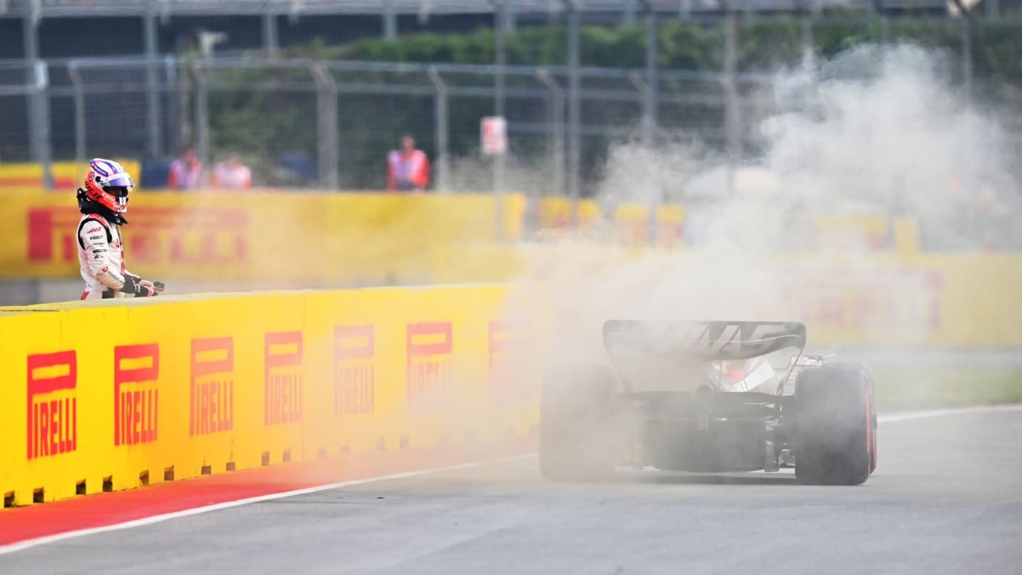MONTREAL, QUEBEC - JUNE 16: Nico Hulkenberg of Germany and Haas F1 looks on as smoke pours from his