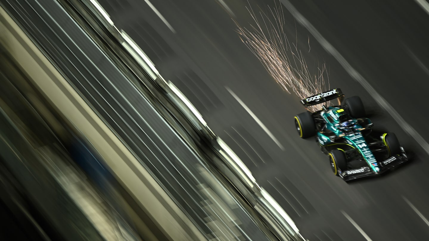 LAS VEGAS, NEVADA - NOVEMBER 17: Sparks fly behind Fernando Alonso of Spain driving the (14) Aston
