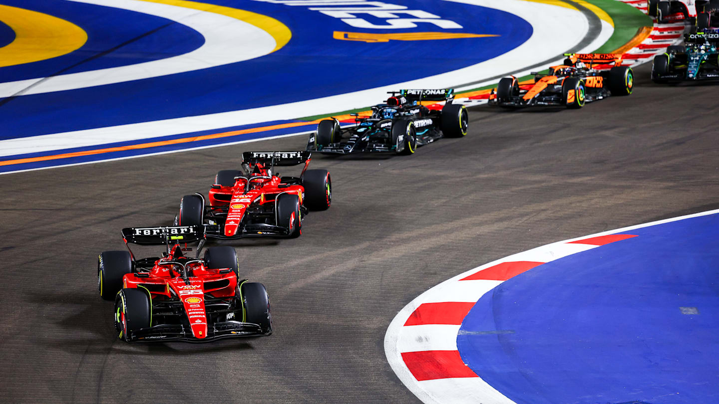 SINGAPORE, SINGAPORE - SEPTEMBER 17: Carlos Sainz of Spain driving (55) the Ferrari SF-23 leads