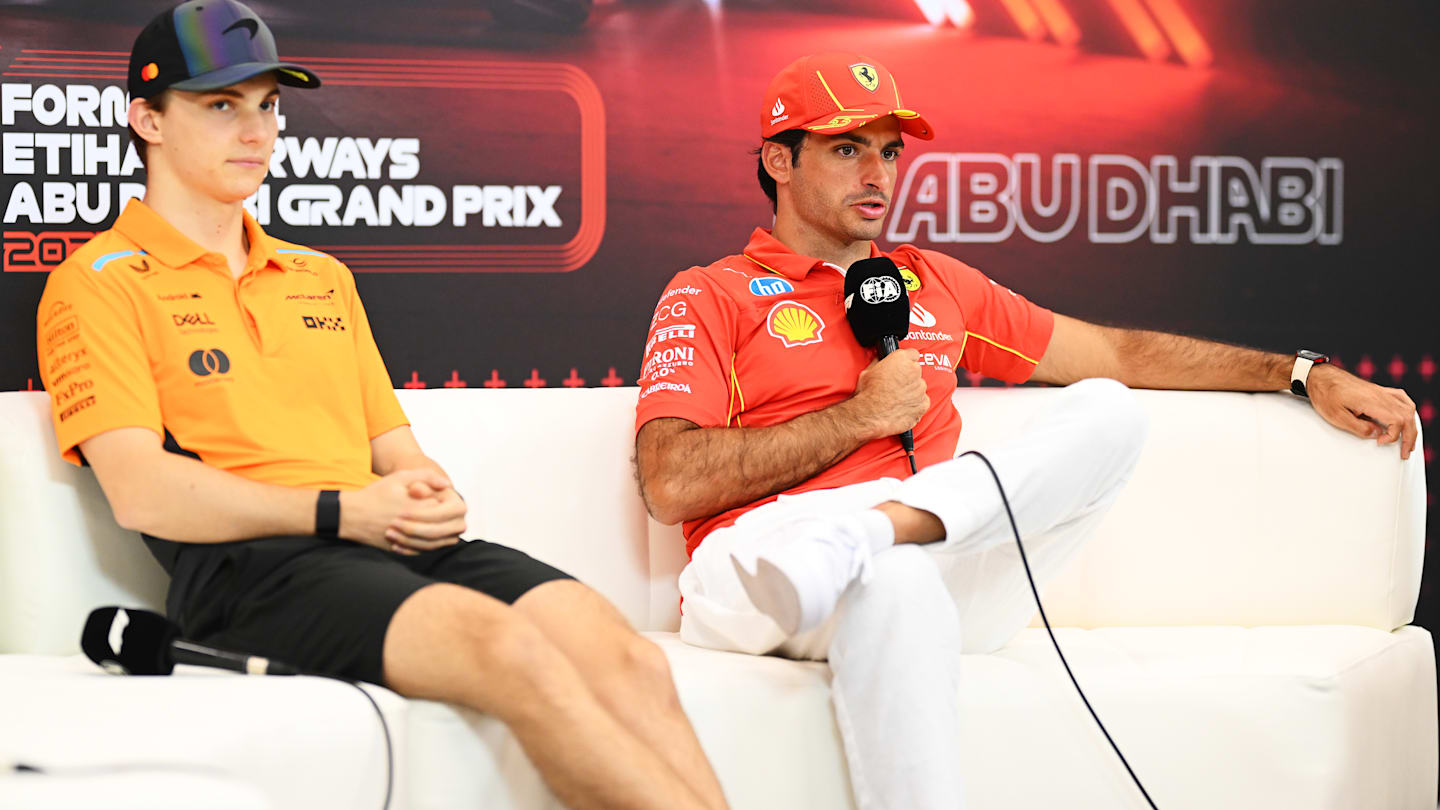 ABU DHABI, UNITED ARAB EMIRATES - DECEMBER 05: Carlos Sainz of Spain and Ferrari and Oscar Piastri