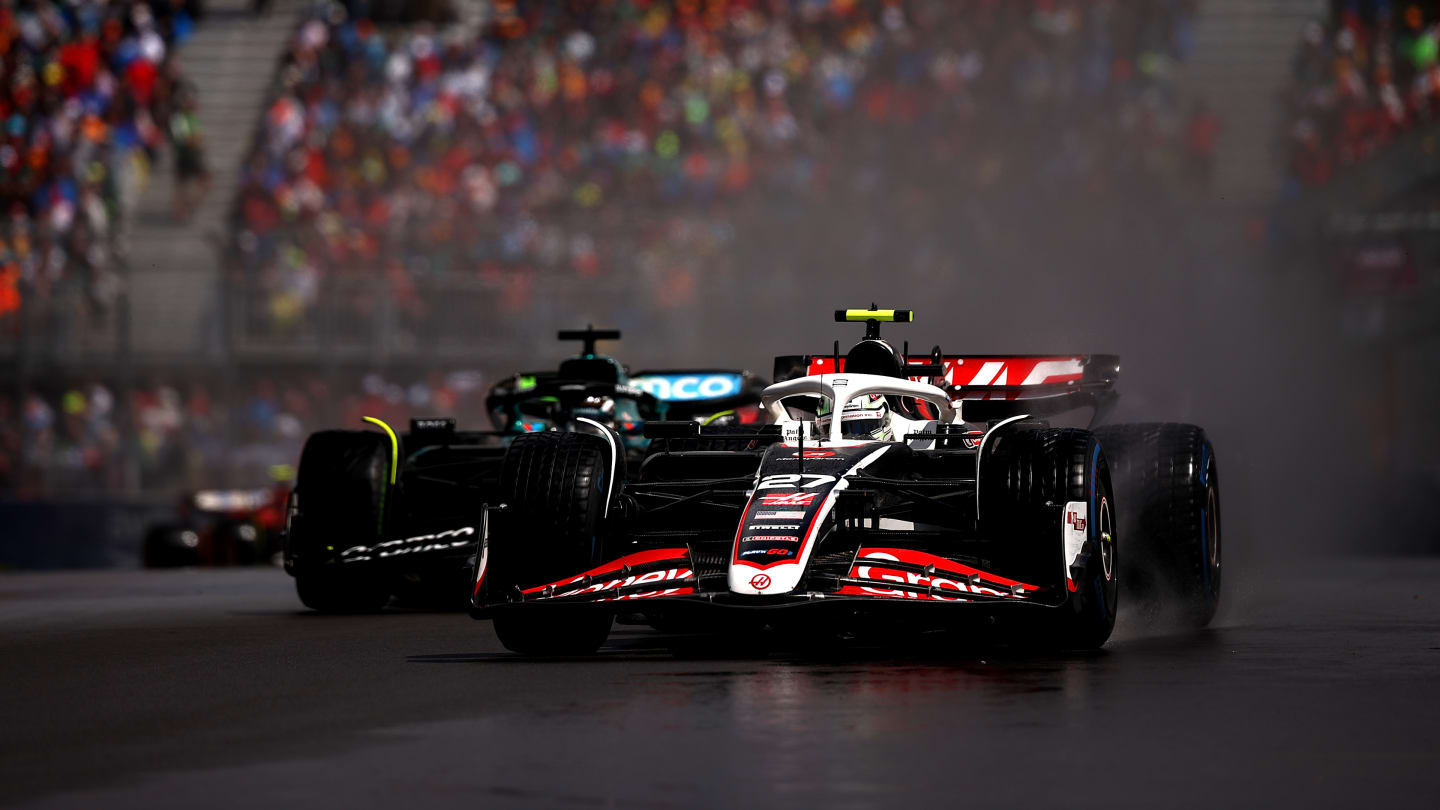 MONTREAL, QUEBEC - JUNE 09: Nico Hulkenberg of Germany driving the (27) Haas F1 VF-24 Ferrari leads Lance Stroll of Canada driving the (18) Aston Martin AMR24 Mercedes on track during the F1 Grand Prix of Canada at Circuit Gilles Villeneuve on June 09, 2024 in Montreal, Quebec. (Photo by Jared C. Tilton - Formula 1/Formula 1 via Getty Images)