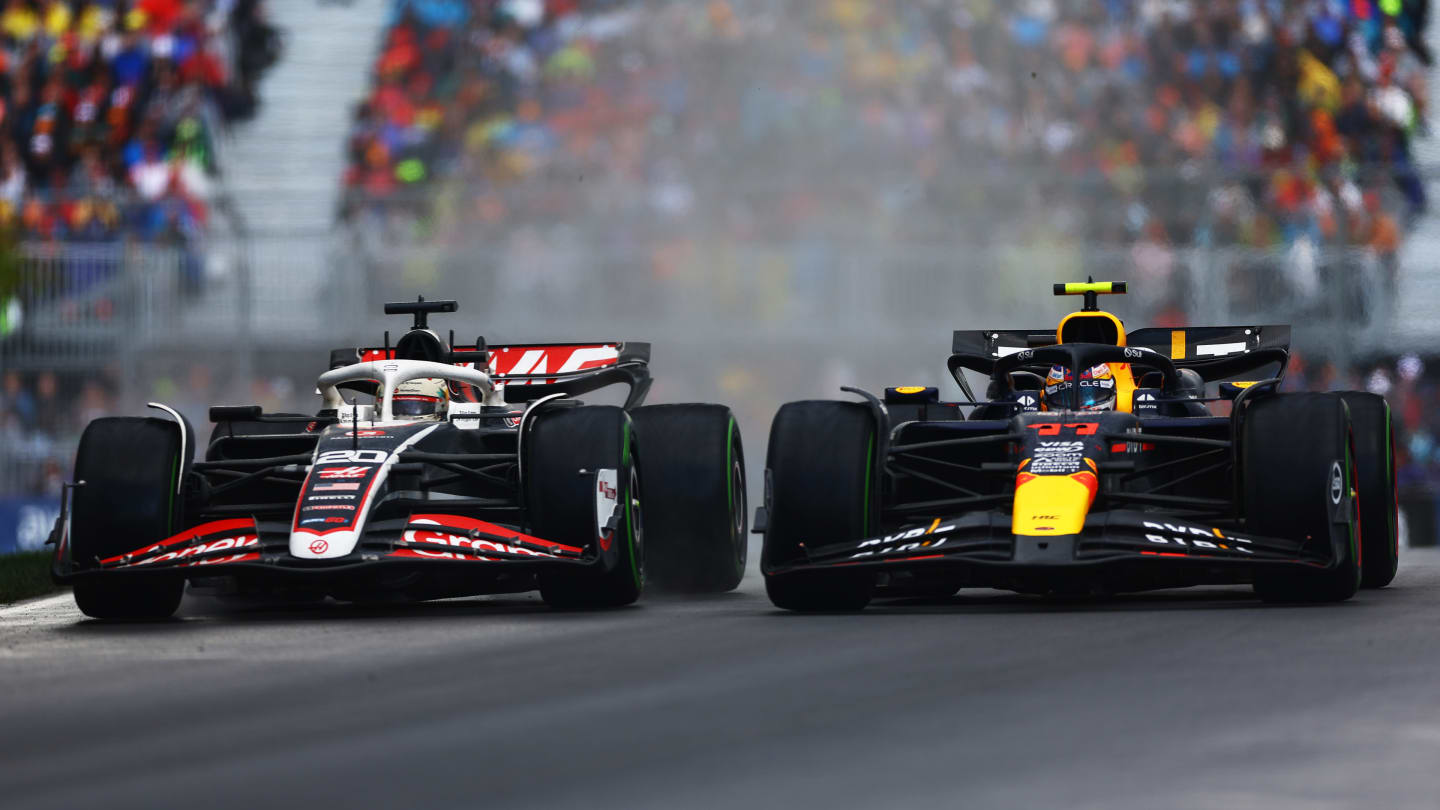 MONTREAL, QUEBEC - JUNE 09: Sergio Perez of Mexico driving the (11) Oracle Red Bull Racing RB20 and Kevin Magnussen of Denmark driving the (20) Haas F1 VF-24 Ferrari battle for position on track during the F1 Grand Prix of Canada at Circuit Gilles Villeneuve on June 09, 2024 in Montreal, Quebec. (Photo by Mark Thompson/Getty Images)
